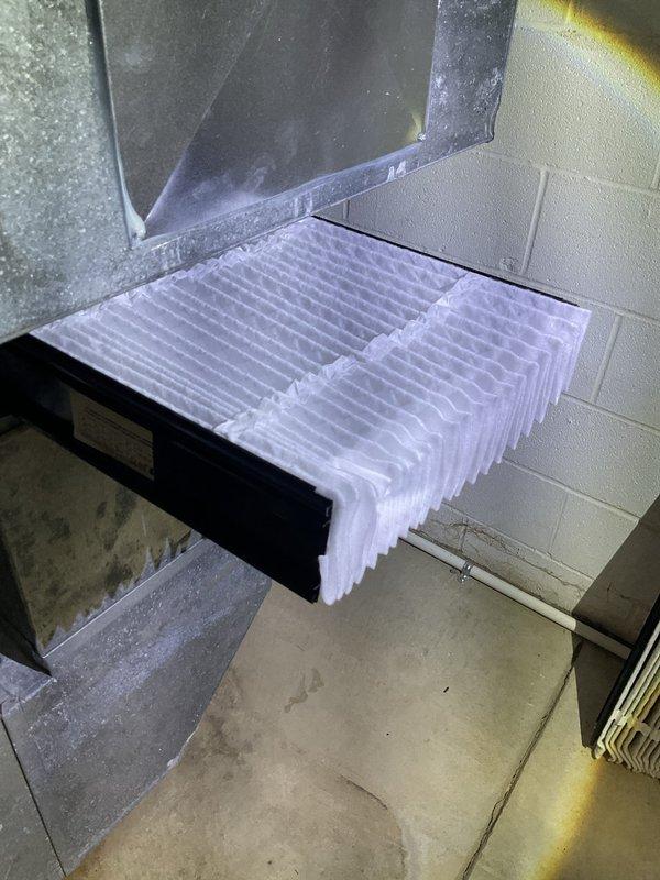 # HVAC Heating Maintenance - Dual System Service

Performed scheduled heating maintenance on two Amana furnace units installed in residential basement mechanical room. Upon inspection, discovered severe frost and ice buildup on evaporator coil of one system, indicating critical airflow restriction or refrigerant issue requiring immediate attention. Documented condition of both heating systems through photographic evidence showing the extensively frosted coil with uniform crystalline accumulation across all fins, as well as overall dual furnace installation with PVC venting configuration. The ice buildup condition suggests potential low refrigerant charge, restricted airflow due to dirty filter or blocked return, or malfunctioning blower motor requiring further diagnostic evaluation and corrective action to restore proper system operation and prevent compressor damage.