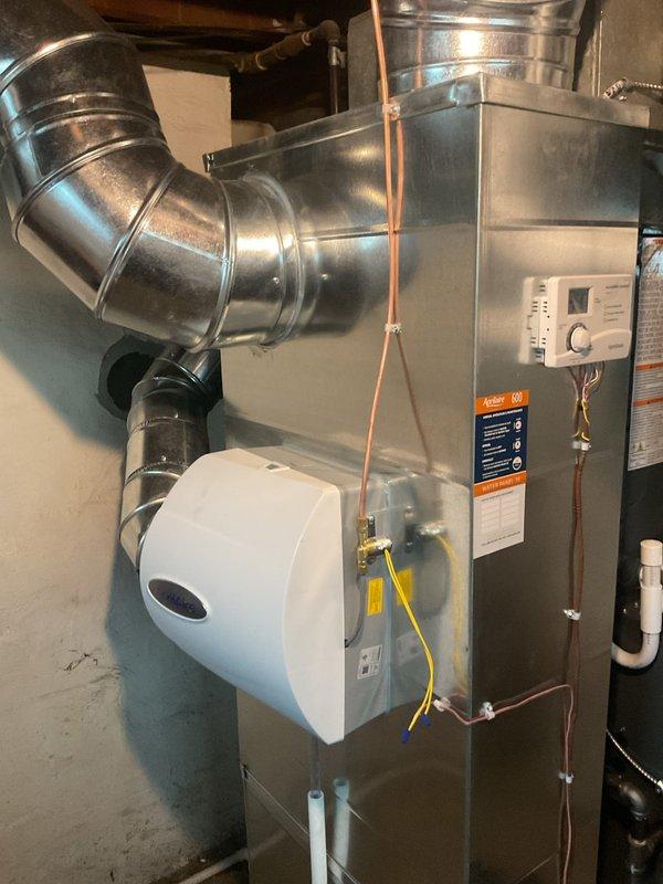 Completed annual preventive maintenance inspection on residential gas furnace system as part of recurring service agreement. Performed comprehensive system evaluation including burner inspection, heat exchanger examination, blower motor operation check, air filter assessment, thermostat calibration verification, and safety control testing. Inspected humidifier unit mounted to furnace, verified proper drainage and water supply connections. Confirmed all ductwork connections secure, refrigerant lines properly mounted, and gas line connections tight with no leaks detected. System operating within manufacturer specifications with all safety controls functioning properly.