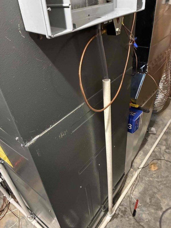 Installed a fan-powered humidifier system with Aprilaire Model 60 wall-mounted digital control unit. The control panel features an LCD display, numbered rotary dial settings, and automatic/manual/test mode functionality, mounted and wired to integrate with the existing HVAC air handler for whole-home humidity management.