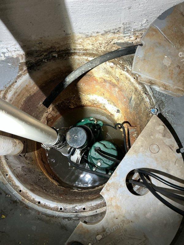 Installed new battery backup sump pump system in basement sump basin to provide reliable water removal and flood protection during power outages. Replaced existing pump assembly with upgraded unit featuring submersible pump, backup power capability, PVC discharge piping, and proper electrical connections to ensure continuous operation and prevent basement flooding.
