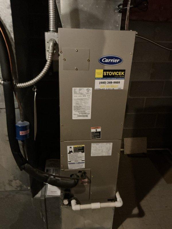 Completed comprehensive heating system maintenance on Carrier air handler unit. Inspected and verified proper operation of AprilAire whole-home humidifier system, confirming digital control display reading 44% relative humidity with all indicator lights functioning correctly. Checked humidifier water panel condition, electrical connections, and control settings. Examined air handler cabinet, verified manufacturer specifications, and inspected all associated ductwork connections. Assessed condensate drainage system and PVC piping for proper operation and secure connections. All components found operating within normal parameters with no service requirements indicated at time of inspection.