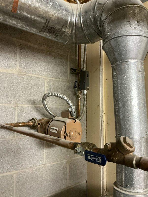 Evaluated existing 71-gallon commercial hot water heater that is currently out of warranty and discussed replacement options with property owner. Assessed the current installation including recirculation pump, copper piping configuration, shut-off valves, and connection points to determine compatibility for either traditional tank-style or tankless water heater replacement. Documented existing equipment setup and utility room conditions to provide accurate estimate for water heater replacement system.