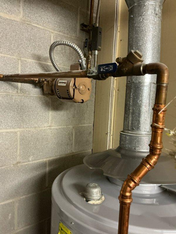 Evaluated existing 71-gallon commercial hot water heater that is currently out of warranty and discussed replacement options with property owner. Assessed the current installation including recirculation pump, copper piping configuration, shut-off valves, and connection points to determine compatibility for either traditional tank-style or tankless water heater replacement. Documented existing equipment setup and utility room conditions to provide accurate estimate for water heater replacement system.