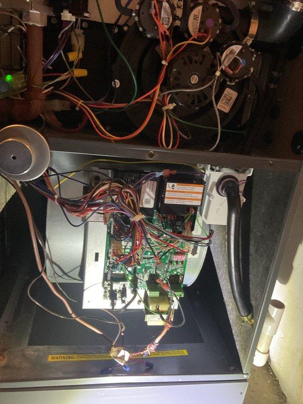 Responded to no heat call on residential gas furnace system. Upon arrival, performed diagnostic inspection of furnace unit with red louvered front panel. Assessed internal components including blower motor assembly, control board, and electrical connections. Inspected wiring harnesses, safety controls, and ignition system. Verified proper operation of all mechanical and electrical components. System restored to full operational status with heat functioning properly.