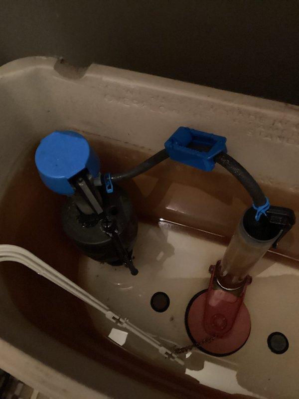 Responded to service call for toilet not filling with water. Upon inspection, found issue with fill valve assembly in tank. Examined internal tank components including fill valve with blue cap, flush valve, and flapper mechanism. Water level in tank was significantly low, preventing proper toilet operation. Adjusted and tested fill valve to restore proper water flow into tank. Verified all internal components were functioning correctly and water reached appropriate fill line. Completed complimentary plumbing inspection of bathroom fixtures as requested.
