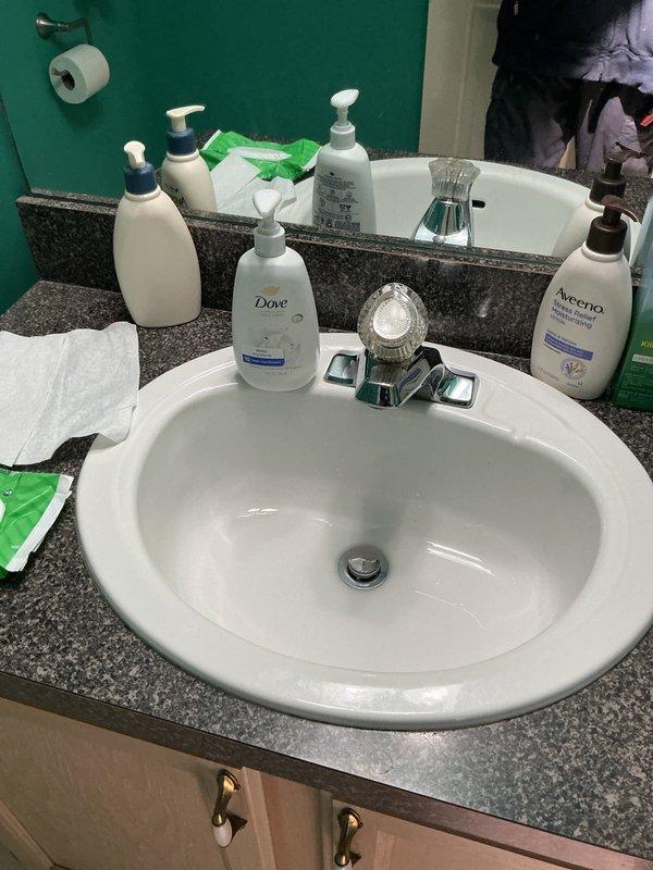 Conducted comprehensive plumbing inspection of residential bathroom fixtures including sink vanity with chrome faucet assembly and bathtub installation with shower diverter system. Documented condition of all visible plumbing components, drain assemblies, and water supply fixtures with photographic evidence for maintenance records.