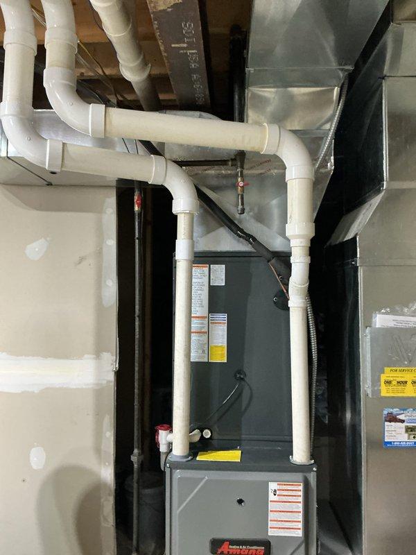 Completed scheduled heating maintenance on residential gas furnace system. Performed comprehensive inspection of furnace unit, verified proper operation of all safety controls, and checked venting system integrity including PVC condensate drain lines. Utilized Klein Tools ET180 differential manometer to measure system static pressure, recording 395 reading to verify airflow performance within manufacturer specifications. Inspected ductwork connections, plenum assembly, and all mechanical components for proper clearances and secure mounting. System operating normally with no deficiencies noted.