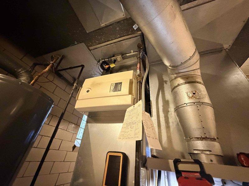 Performed comprehensive new homeowner system evaluation of HVAC equipment installed in confined utility space. Inspected blower motor assembly, electrical connections, ductwork integrity, and associated plumbing components including copper piping and valve assemblies. All equipment photographed and documented, with system confirmed operational and ready for homeowner occupancy.