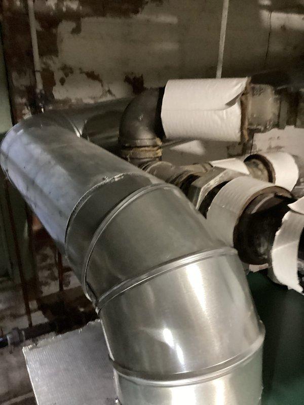 Completed first-year preventive maintenance on steam boiler system, including comprehensive inspection of all major components, ductwork, and piping connections. Documented existing conditions of insulated steam lines, exhaust ductwork, and distribution piping, noting age-related discoloration on PVC condensate lines and connections. All equipment found operational with no immediate repairs required at this time.