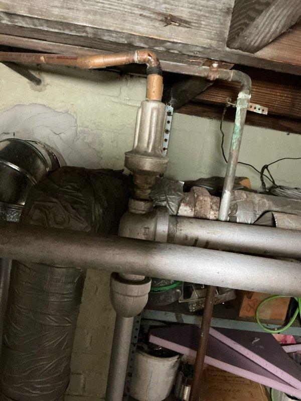 Performed comprehensive evaluation of existing boiler system and associated piping infrastructure dating from the 1970's era. Assessed aged copper distribution piping showing significant oxidation and patina, finned heat exchanger components, and overall system configuration within basement mechanical space. Documented current conditions of HVAC ductwork, electrical panel integration, and plumbing connections to provide multiple replacement options for outdated heating system and deteriorated piping network.