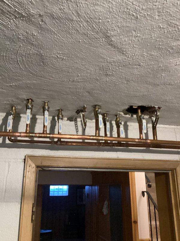 Completed comprehensive plumbing valve replacement in basement, removing and disposing of 17 outdated gate valves and installing new ball valves with necessary fittings throughout the horizontal piping system. Installed new pressure reducing valve assembly on vertical copper mainline, replaced main water shut-off valve, and added two frost-free hose bibs to exterior water supply system. All copper connections were properly fitted, secured with mounting brackets, and tested for proper operation and leak-free performance.
