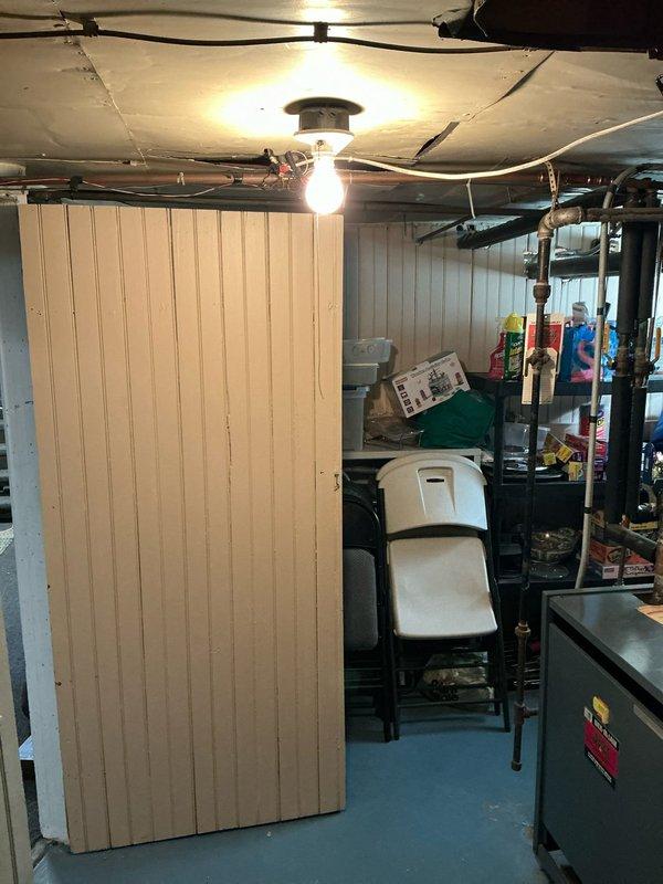 Conducted on-site evaluation for mini split system installation options in residential property with existing boiler heating system. Assessed basement utility area and adjacent room with wood paneling to determine optimal equipment placement and review space constraints for proposed ductless mini split configuration.
