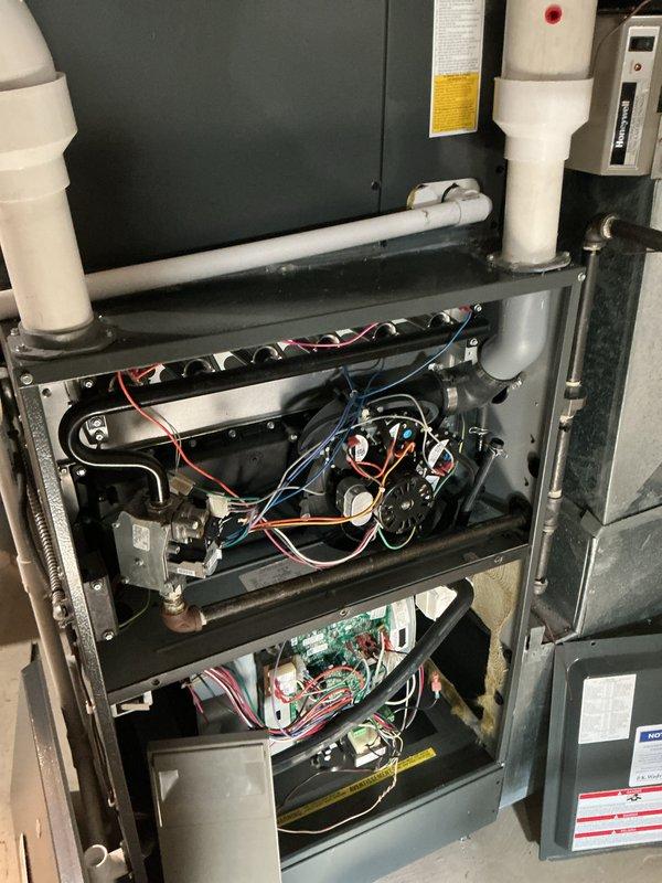 Completed scheduled heating maintenance on residential furnace system as part of ongoing preventative maintenance program. Performed comprehensive inspection of dual blower motor assembly, verified all electrical connections and wire harnesses for proper termination and security, and examined control board functionality. All components including motors, circuit board, condensate drainage system, and PVC venting found to be operating within normal parameters with no deficiencies noted.