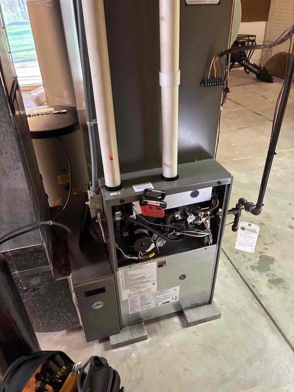 Completed comprehensive heating system tune-up on residential gas furnace and inspected associated HVAC components in basement utility area. Performed standard maintenance procedures including inspection of blower motor assembly, electrical connections, burner operation, and heat exchanger integrity; verified proper venting through PVC exhaust and intake pipes; and confirmed all safety controls functioning within manufacturer specifications.
