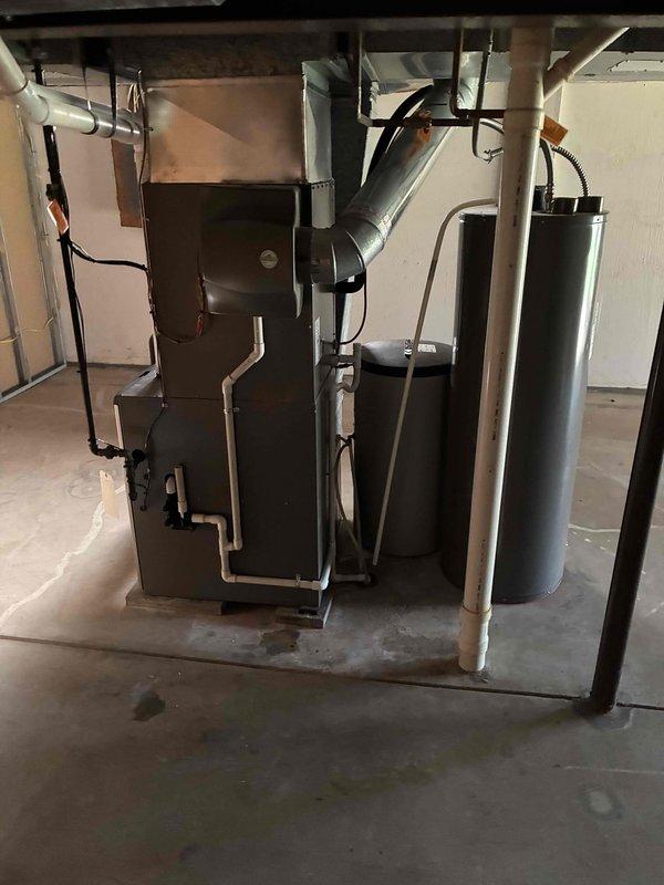 Completed comprehensive heating system tune-up on residential gas furnace and inspected associated HVAC components in basement utility area. Performed standard maintenance procedures including inspection of blower motor assembly, electrical connections, burner operation, and heat exchanger integrity; verified proper venting through PVC exhaust and intake pipes; and confirmed all safety controls functioning within manufacturer specifications.