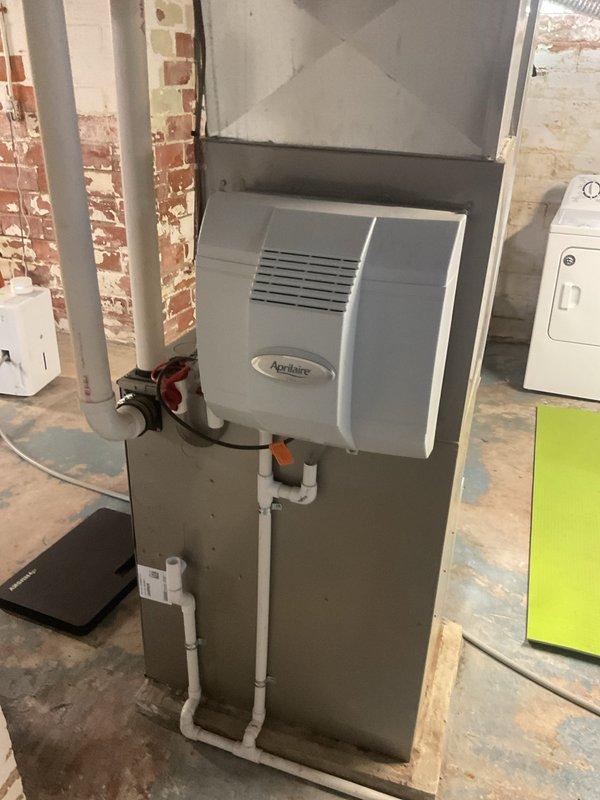 Completed comprehensive heating system maintenance on residential HVAC unit with integrated Aprilaire humidifier in basement utility area. Performed standard inspection of furnace components, ductwork transitions, refrigerant lines, and associated plumbing connections including water supply valve for humidification system. All equipment found operating within normal parameters with no immediate repairs required.