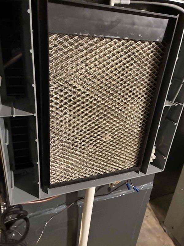 # HVAC Maintenance Completed

Performed annual preventative maintenance on residential forced-air furnace system as part of scheduled service plan. Conducted comprehensive inspection of air handler unit, including examination of evaporator coil with diamond-pattern mesh filter showing moderate dust accumulation consistent with normal operation. Inspected blower motor assembly, electrical connections, and control components. Verified proper wire routing and secure termination of all electrical connections including red, yellow, white, black, and green conductors. Examined compressor motor mounting and hardware for stability and proper operation. All system components found to be functioning within normal parameters with no immediate repairs required.
