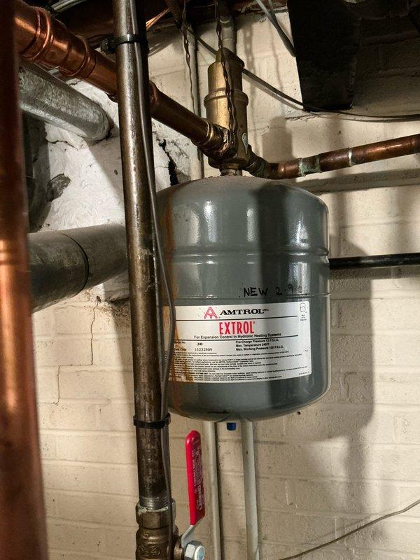 Performed on-site assessment for boiler replacement on existing GWA 052N-S unit experiencing chronic pilot assembly corrosion. Inspected current hydronic heating system including Amtrol Extrol expansion tank, copper distribution piping, and associated mechanical components. Documented existing equipment configuration and provided replacement options to address ongoing pilot metal lead rust failure affecting system reliability.