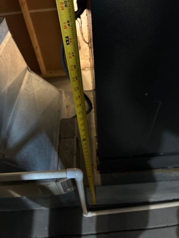 Conducted comprehensive site evaluation and documentation for HVAC system replacement in attic installation area. Assessed existing air handler unit configuration, condensate drain line routing with PVC piping and connection fittings, and sheet metal ductwork arrangement. Documented clearance measurements and structural framing dimensions to determine equipment compatibility and access requirements for replacement unit installation. Verified available workspace within confined mechanical area and photographed current system components including safety labels, insulation conditions, and drainage infrastructure to develop accurate replacement specifications and installation plan.