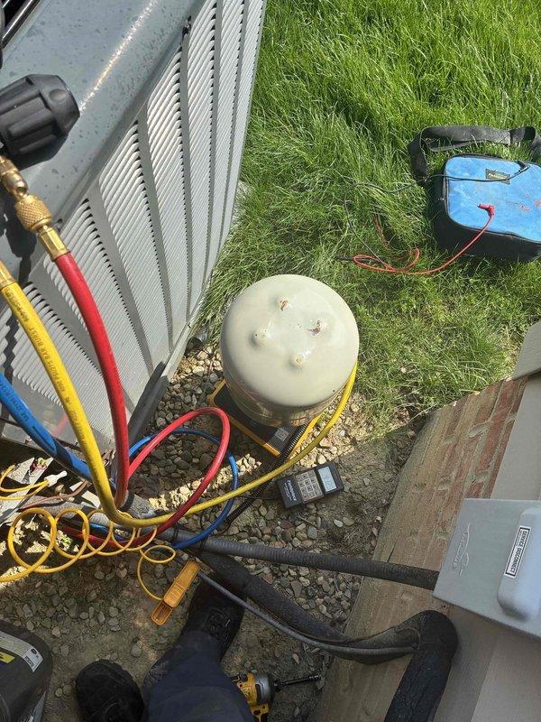 Performed refrigerant leak search using UV dye injection on residential air conditioning system. Connected manifold gauge set to service ports and introduced fluorescent dye into the refrigerant circuit to identify leak source. System will require follow-up visit to inspect for dye traces under UV light after sufficient circulation time, allowing for precise leak location identification and subsequent repair.