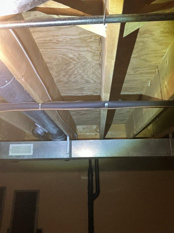 Responded to warranty callback for excessive noise and vibration from recently installed air conditioning system. Inspected outdoor condenser unit and found installation on gravel pad contributing to vibration transmission through ground. Verified all mounting hardware secure and refrigerant lines properly supported. Checked indoor ductwork connections in attic space and confirmed proper attachment points and insulation placement. System operating within normal parameters with no mechanical defects identified.