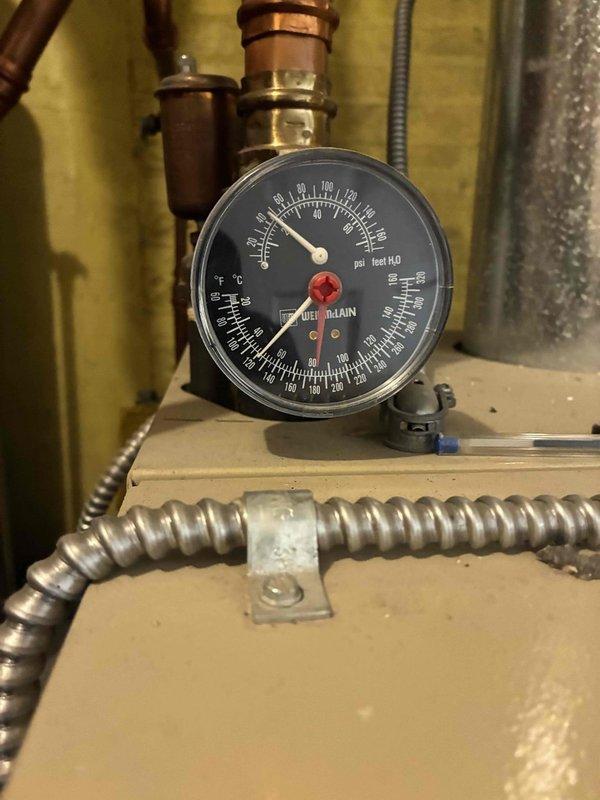 Completed comprehensive boiler tune-up and system inspection. During service, observed and documented loose expansion tank mounting strap that requires resecuring to prevent potential tank displacement. Advised that while HVAC technician can assess the situation, a licensed plumber may be needed for proper repair of the plumbing support system. System pressure readings verified and photographed for service records.