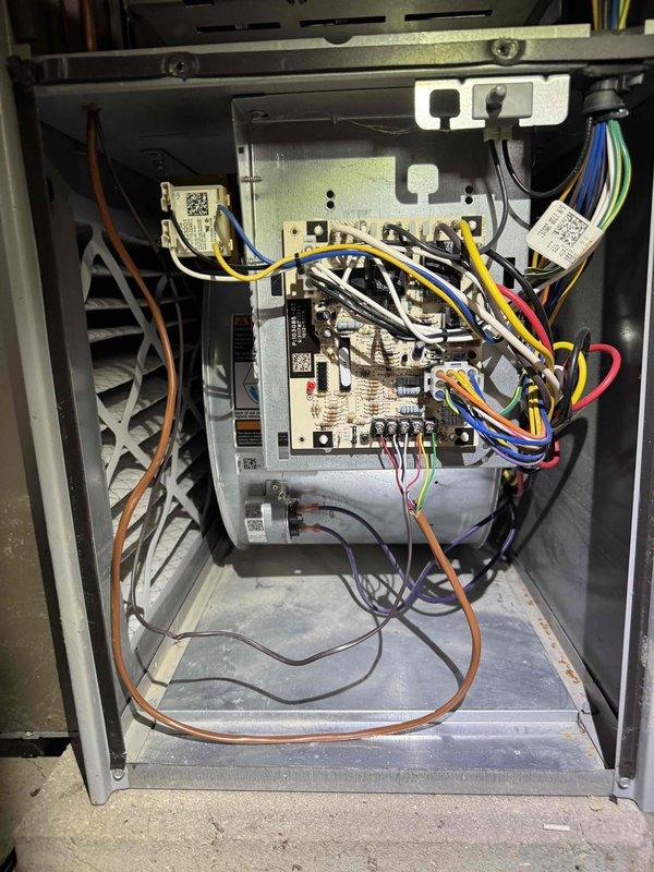 Returned to complete wiring repair on HVAC system. Reconnected and secured electrical connections at capacitor terminals and control board, ensuring all wire terminations were properly fastened and routed. Verified system operation upon completion of repair work.