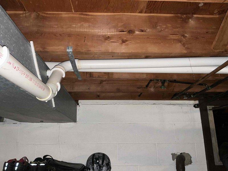 Conducted on-site assessment for furnace and hot water tank replacement in residential basement utility area. Evaluated existing HVAC system including aged galvanized metal ductwork, white residential furnace unit, and associated PVC drainage/ventilation piping. Documented current equipment conditions, structural layout of exposed ceiling joists, and mechanical system configurations to provide comprehensive replacement options for both heating equipment and water heater.