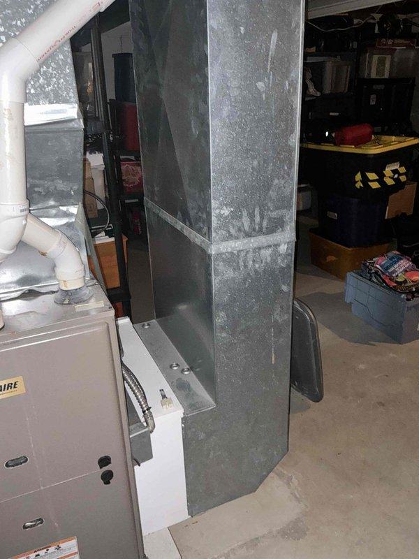 Conducted on-site assessment for furnace and hot water tank replacement in residential basement utility area. Evaluated existing HVAC system including aged galvanized metal ductwork, white residential furnace unit, and associated PVC drainage/ventilation piping. Documented current equipment conditions, structural layout of exposed ceiling joists, and mechanical system configurations to provide comprehensive replacement options for both heating equipment and water heater.