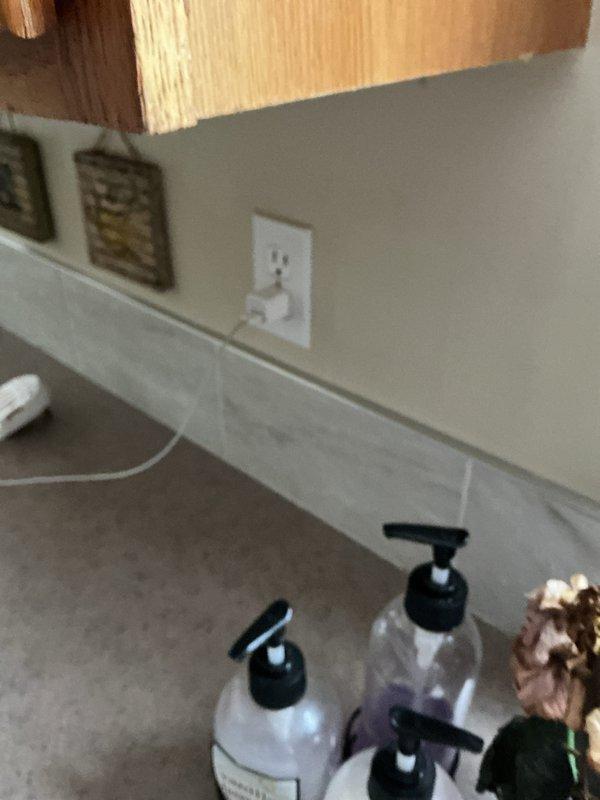 Conducted comprehensive afternoon electrical inspection of residential property. Examined and documented mechanical space infrastructure including electrical routing through floor joists alongside plumbing systems, and verified proper installation and functionality of bathroom GFCI outlet with connected device. All electrical components inspected met current code requirements and operational standards.