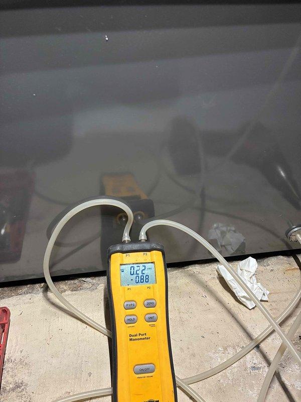 Completed outdoor air conditioning unit installation on exterior brick wall with proper refrigerant line routing, electrical conduit installation, and equipment mounting on concrete pad. Performed system pressure testing and verification using digital manometer to ensure proper refrigerant charge and system operation within manufacturer specifications.