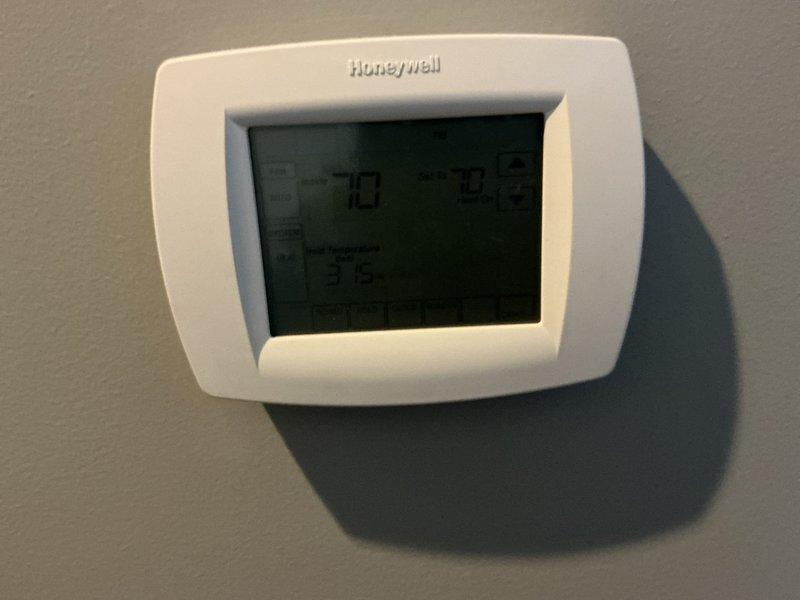 Conducted HVAC system evaluation for replacement options on existing York Infinity 5-ton heat pump system. Inspected current equipment including York furnace model GM9V100C20UP12B, documented system specifications and serial numbers, and assessed thermostat functionality with Honeywell digital control displaying proper temperature readings. Researched available utility rebate programs for heat pump replacement to provide comprehensive upgrade recommendations.