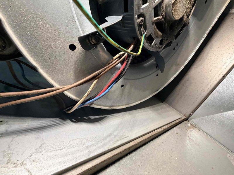 Responded to no heat call on aging furnace system. Upon inspection, identified blower motor assembly with worn electrical connections and accumulated dust buildup affecting system operation. Diagnosed motor wiring configuration, verified proper electrical connections, and assessed overall condition of blower assembly and housing components to restore heating functionality.