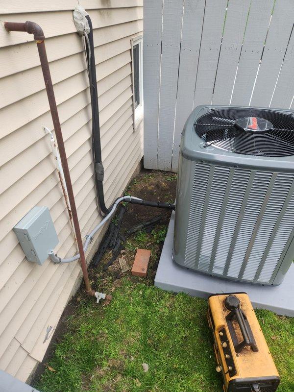 Completed full HVAC system installation including 80% AFUE gas furnace and air conditioning condenser unit. Installed new outdoor AC unit on concrete pad with proper refrigerant line routing along exterior wall, mounted electrical disconnect box, and ensured all connections were secure and properly insulated. System tested and operational upon completion.