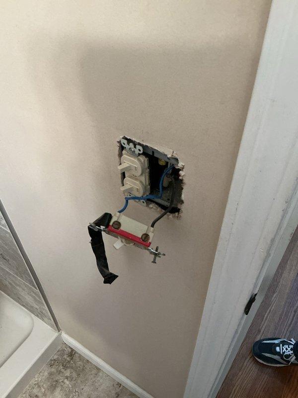 Responded to service call for non-functional attic fan that ceased operation after being turned off following previous season's wiring issue. Conducted diagnostic inspection of attic-mounted ventilation system, examining blower wheel assembly and associated electrical connections. Assessed exposed electrical outlet box with visible blue and white conductors to determine circuit integrity and switching mechanism functionality. Evaluated mounting hardware, junction box installation, and wire terminations for proper connections and code compliance. Investigated secondary concern regarding malfunctioning light switch. Documented existing conditions through photographic evidence showing blower assembly mounted to structural framing and exposed wiring at wall-mounted junction box location. Provided homeowner with repair versus replacement options for attic ventilation system restoration.