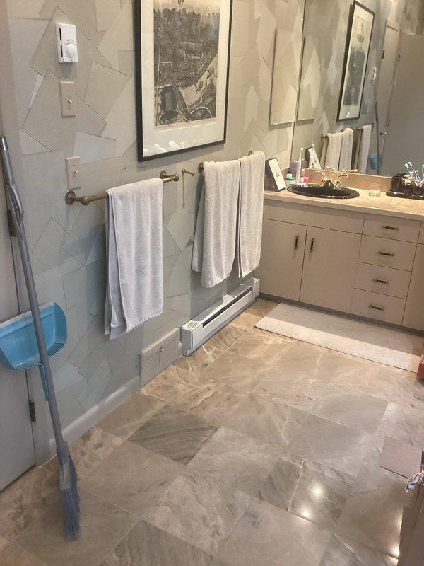 Installed new electric baseboard heater in bathroom. Ran electrical wiring through attic space to supply dedicated circuit for heating unit. Mounted baseboard heater at floor level along wall near shower enclosure, ensuring proper clearances from plumbing fixtures and moisture sources per code requirements.