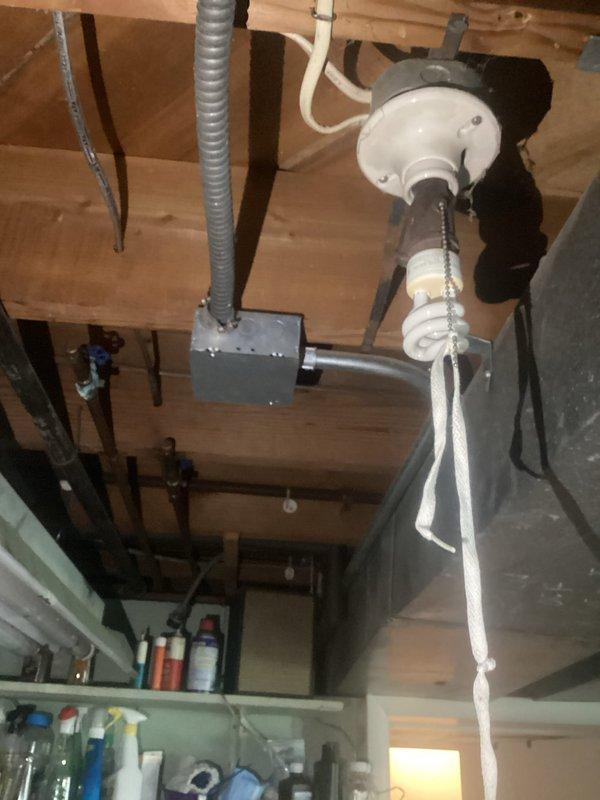 Conducted comprehensive electrical assessment for panel replacement in residential garage installation. Evaluated existing electrical panel configuration with multiple circuit breakers, main disconnect, and current wire routing including service entrance conductors and branch circuit wiring. Documented panel condition, breaker arrangement, and surrounding infrastructure including overhead garage door operator system with junction box and conduit connections to provide detailed replacement specifications and material requirements for complete panel upgrade.