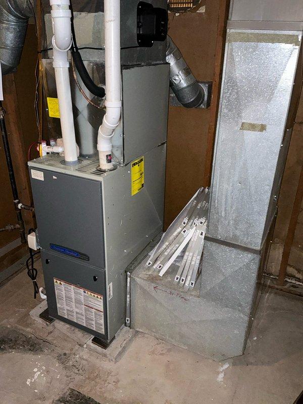 Diagnosed furnace with cracked heat exchanger and provided replacement options to customer. Documented existing HVAC system installation including furnace unit, ductwork connections, venting configuration, and electrical components for estimate preparation.