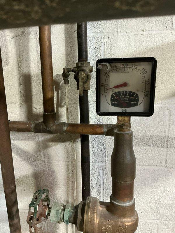 Conducted diagnostic evaluation of residential boiler system and provided replacement options due to failed heat exchanger. Documented existing hydronic piping configuration, pressure/temperature gauges, and boiler access panel condition with photographic evidence to support estimate for complete system replacement.