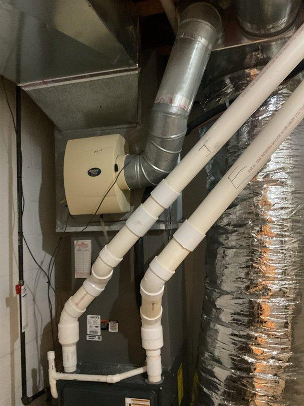 Completed comprehensive preventive maintenance on residential forced-air heating system. Performed thorough inspection of furnace cabinet, blower motor assembly, and all electrical connections. Verified proper operation of control board, checked wire terminations and safety interlocks, and confirmed all warning labels were intact and legible. Inspected ductwork, humidifier unit, and condensate drain lines throughout mechanical room for proper installation and functionality. All components found operating within normal parameters with no immediate service needs identified.