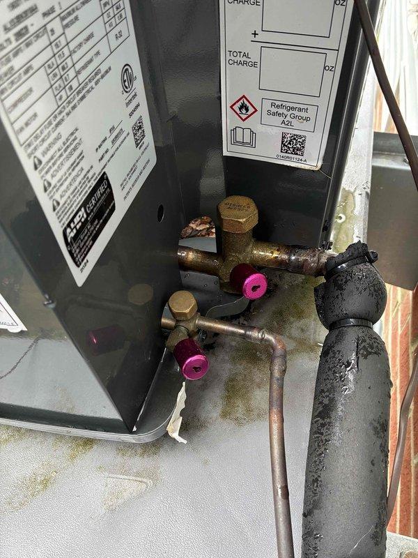 Completed first-year cooling maintenance on residential air conditioning system as part of annual service plan. Performed comprehensive inspection of condensing unit, verified refrigerant charge levels on A2L refrigerant system, checked service valve operation, inspected copper line sets and insulation for proper condition, examined condensate drainage system with funnel trap assembly, and documented equipment specifications. All components found operating within normal parameters with no deficiencies noted.
