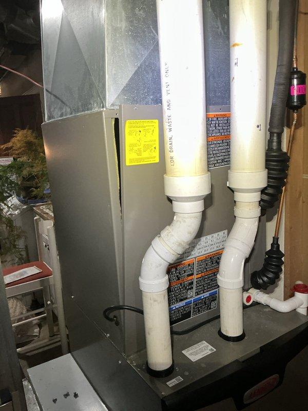 Responded to no cooling complaint on residential HVAC system. Upon arrival, performed system inspection of air handler and evaporator coil assembly. Visually examined evaporator coil for potential airflow restrictions, refrigerant leaks, or component failures. Documented equipment condition including copper refrigerant lines, aluminum fin assembly, and condensate removal system. System evaluation revealed accessible components in basement installation with PVC condensate piping and electrical connections intact. Captured diagnostic photos of air handler unit and evaporator coil for service records.