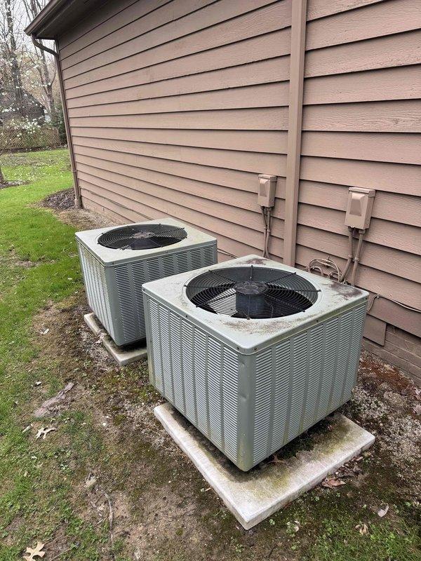 Responded to no-cooling call on secondary air conditioning system. Upon arrival, performed diagnostic evaluation of outdoor condensing unit and indoor air handling components. Inspected dual condenser setup positioned on exterior concrete pads, verified electrical connections and refrigerant line routing. Evaluated basement air handler installation, checked ductwork integrity and system controls. Completed troubleshooting procedures to identify cause of system failure and provided customer with findings and repair recommendations for aging HVAC equipment.