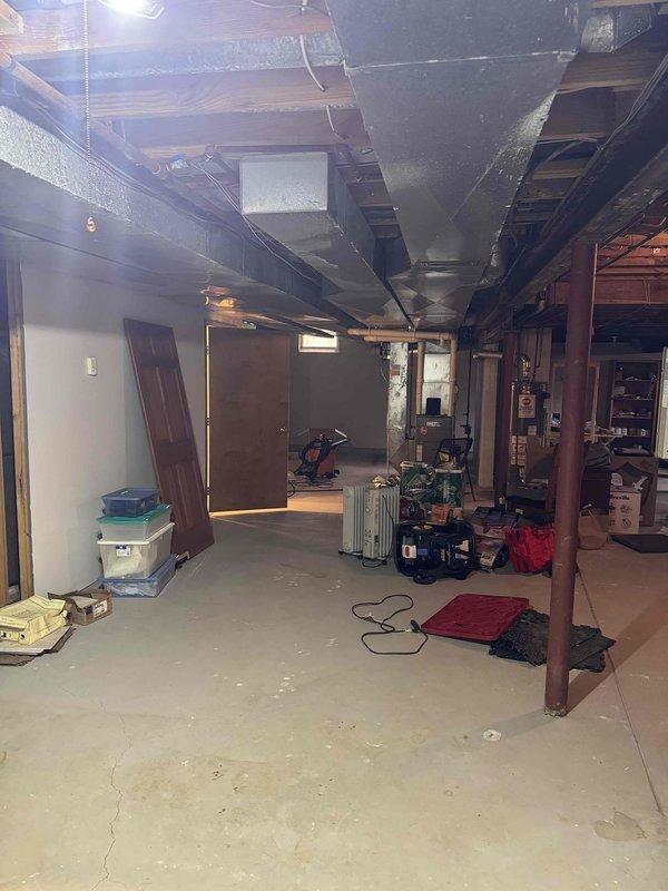 Responded to no-cooling call on secondary air conditioning system. Upon arrival, performed diagnostic evaluation of outdoor condensing unit and indoor air handling components. Inspected dual condenser setup positioned on exterior concrete pads, verified electrical connections and refrigerant line routing. Evaluated basement air handler installation, checked ductwork integrity and system controls. Completed troubleshooting procedures to identify cause of system failure and provided customer with findings and repair recommendations for aging HVAC equipment.