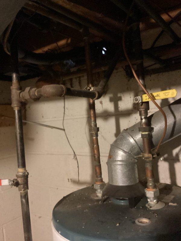 Performed on-site assessment of leaking 50-gallon gas water heater (Fury Everkleen model) installed in basement utility area. Documented existing unit condition, noting active leak evidenced by significant water staining and discoloration on concrete floor surrounding base of tank. Evaluated copper supply line connections, gas piping configuration, and venting system. Provided comprehensive estimate for replacement of failed water heater with new 50-gallon gas unit, including removal and disposal of existing equipment, installation of replacement unit to current code standards, and connection to existing plumbing and gas infrastructure.