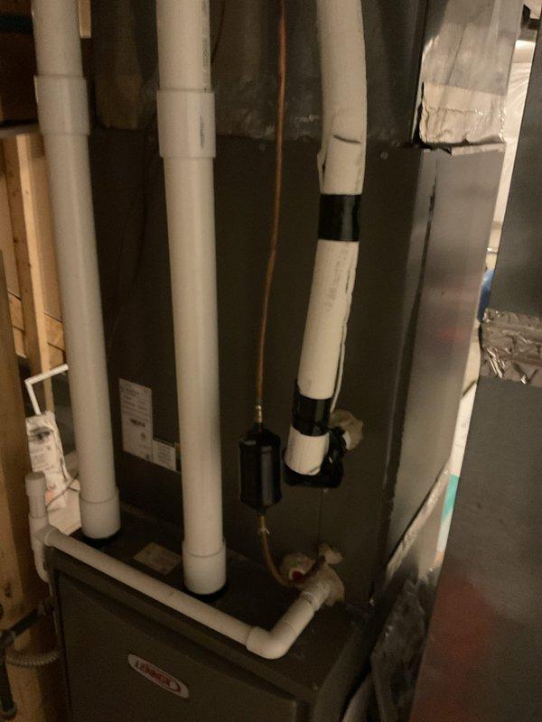 Completed comprehensive heating and cooling maintenance on residential HVAC system located in basement utility area. Performed standard maintenance procedures on furnace unit and associated ductwork, including inspection of sheet metal housing, ventilation connections, and air distribution system. Verified proper operation of PVC drainage lines, inspected gas supply connections, and confirmed all mechanical components were functioning within normal parameters for continued reliable system performance.