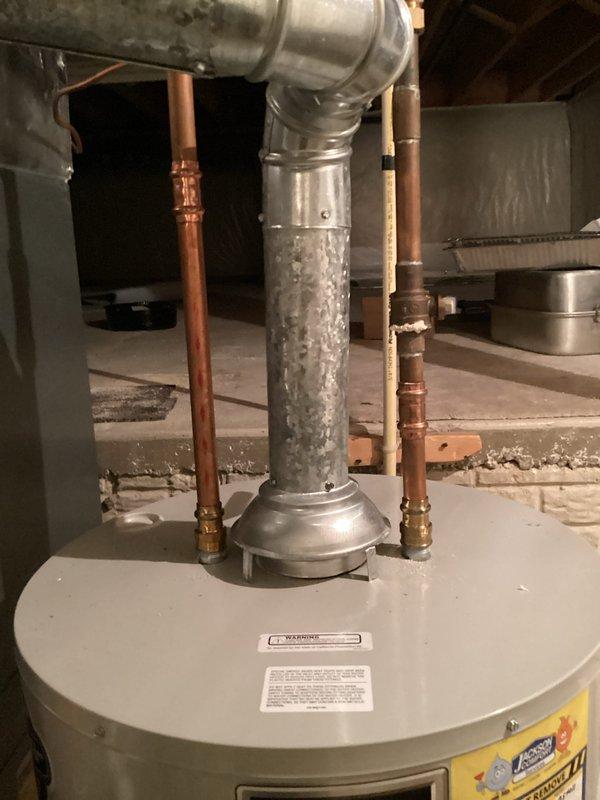 Performed routine maintenance flush on residential tanked water heater located in basement utility area. Drained sediment and mineral buildup from tank bottom through drain valve, then refilled system and verified proper operation. Inspected copper supply lines, brass fittings, and connections for leaks or corrosion—all components found in satisfactory condition. Confirmed water heater returning to normal operating temperature following flush procedure.