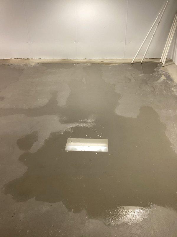 Responded to report of loud gurgling noises throughout all household sink drains. Upon arrival, discovered a significant pipe burst resulting in extensive flooding of the basement utility area with several inches of standing water covering the concrete floor. Identified the source of the leak in the plumbing system near the utility sink area where copper supply lines showed signs of failure. Shut off the main water supply to prevent further flooding and water damage. Assessed the extent of water infiltration, noting moisture damage along wall-floor junctions and previous water staining. Documented the flooded conditions and plumbing configuration for repair planning. The gurgling sounds reported by the customer were determined to be related to the compromised pipe system and drainage issues caused by the burst pipe event.