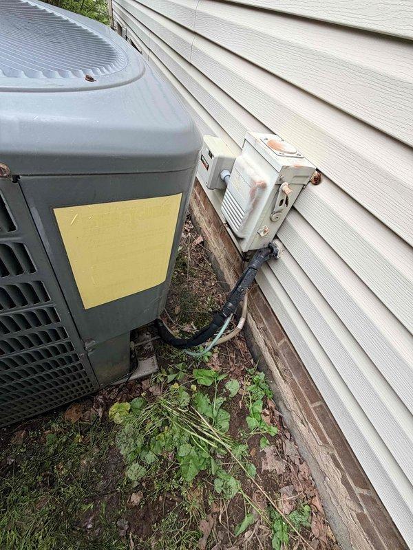 Completed comprehensive air conditioning tune-up on outdoor condenser unit positioned against building exterior. Performed standard maintenance procedures including inspection of electrical components, disconnect box, and refrigerant lines. Customer expressed interest in enrolling in maintenance plan during service visit.
