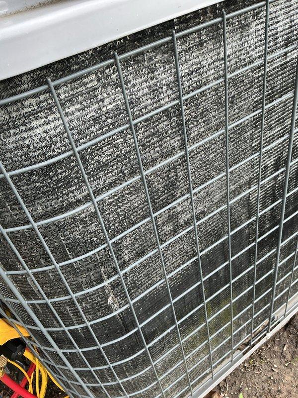 # HVAC Maintenance - Cooling System Service

Performed comprehensive annual maintenance on outdoor condensing unit experiencing continuous operation following thermostat upgrade. Upon arrival, found system disconnected by homeowner due to non-stop runtime issue. Conducted thorough inspection revealing heavily clogged condenser coils with extensive dirt, dust, and debris accumulation indicating deferred maintenance.

Performed complete coil cleaning to restore proper airflow and heat transfer efficiency. Cleaned protective wire grille and removed accumulated debris from unit exterior and surrounding area. Verified proper unit operation on concrete pad with adequate clearance from building structure and landscaping materials.

Addressed thermostat compatibility concerns and provided guidance on proper system operation following recent control upgrade. Evaluated unit placement and discussed relocation options as previously requested. System restored to normal operation with improved effic